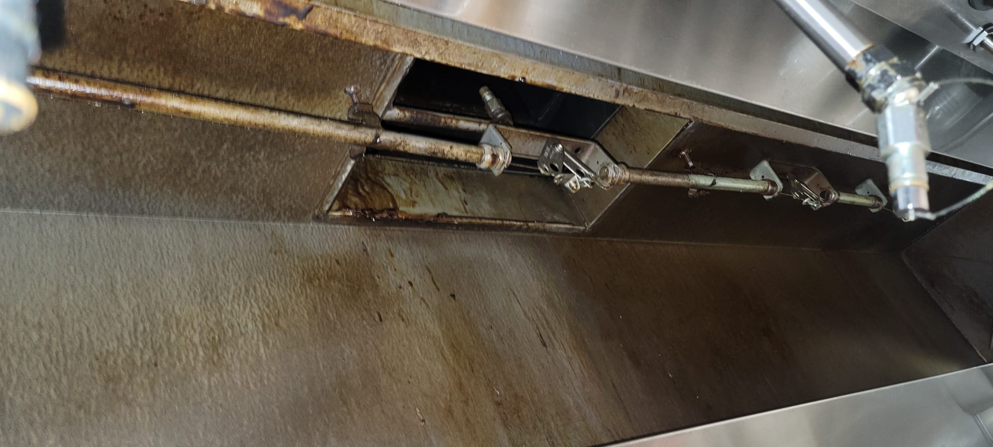 Stainless steel hood over a commercial kitchen cook line