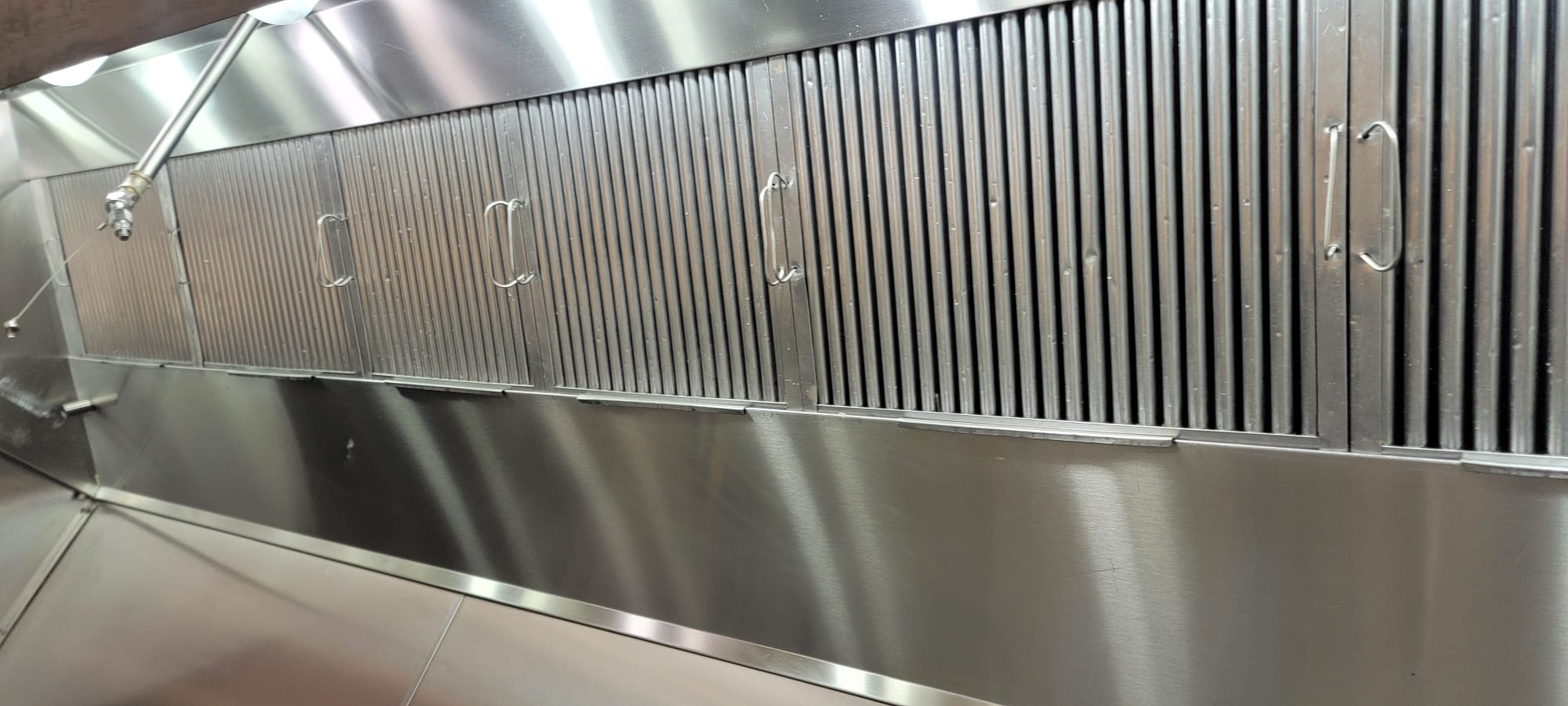 Cornerstone technician scrubbing a kitchen exhaust hood