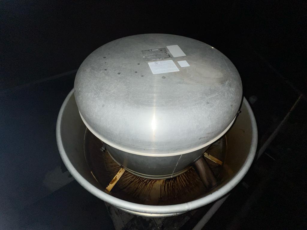 Chef cooking on a restaurant range beneath an exhaust hood