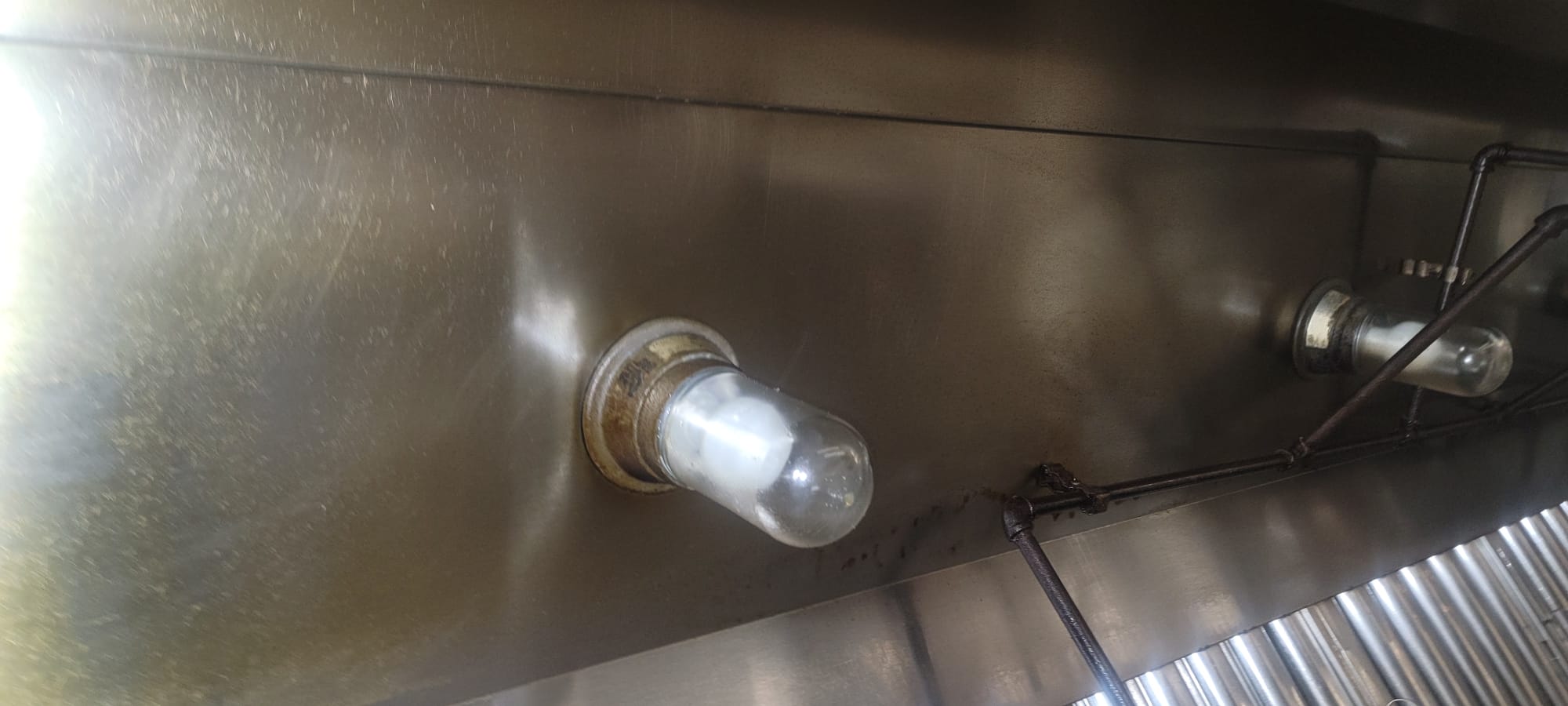 Chef cooking on a restaurant range beneath an exhaust hood