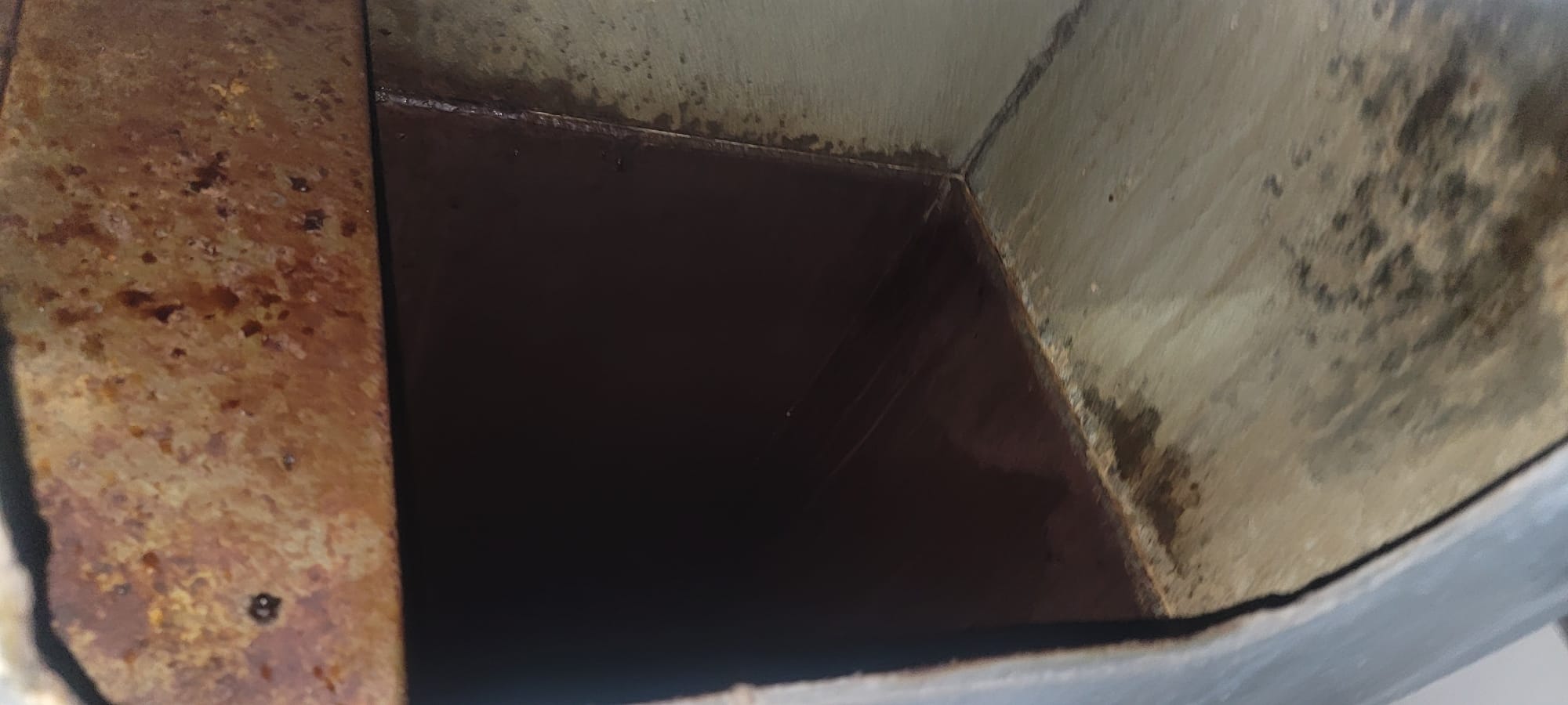 Chef cooking on a restaurant range beneath an exhaust hood