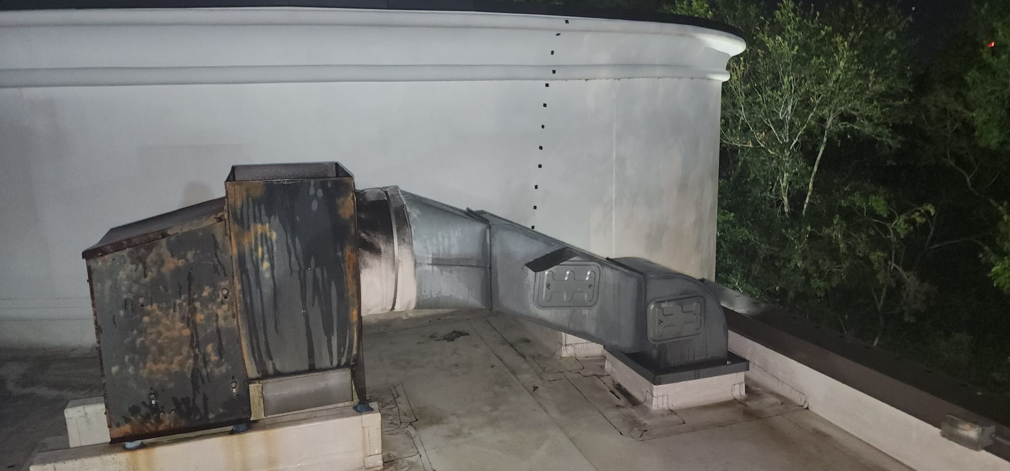 Chef cooking on a restaurant range beneath an exhaust hood