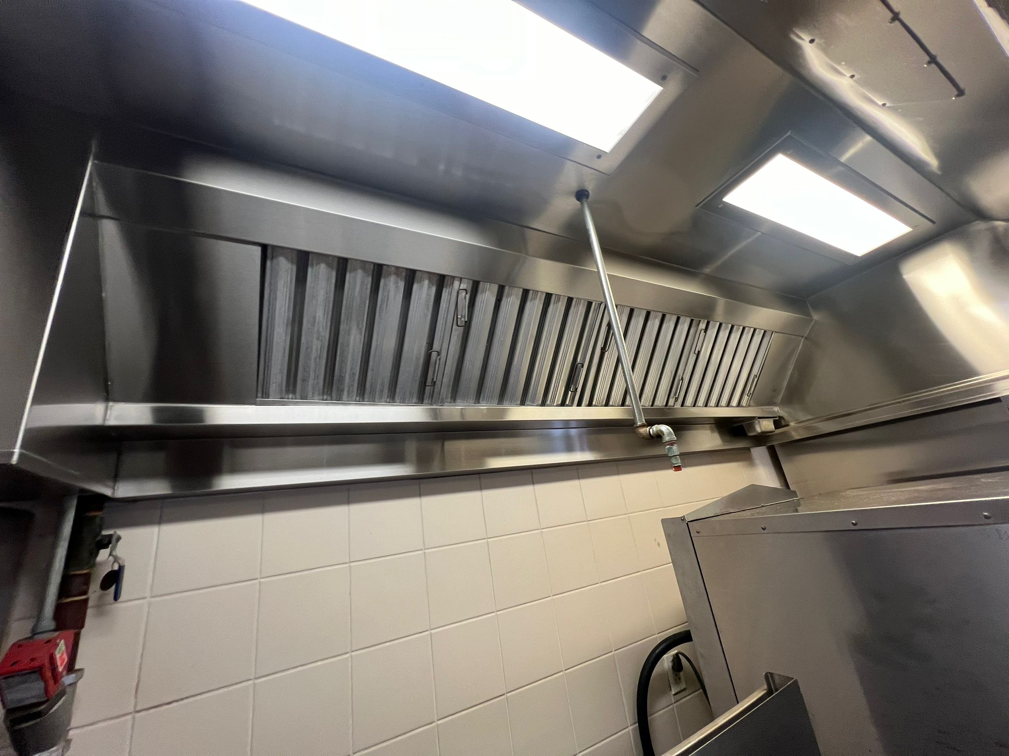 Cornerstone technician scrubbing a kitchen exhaust hood
