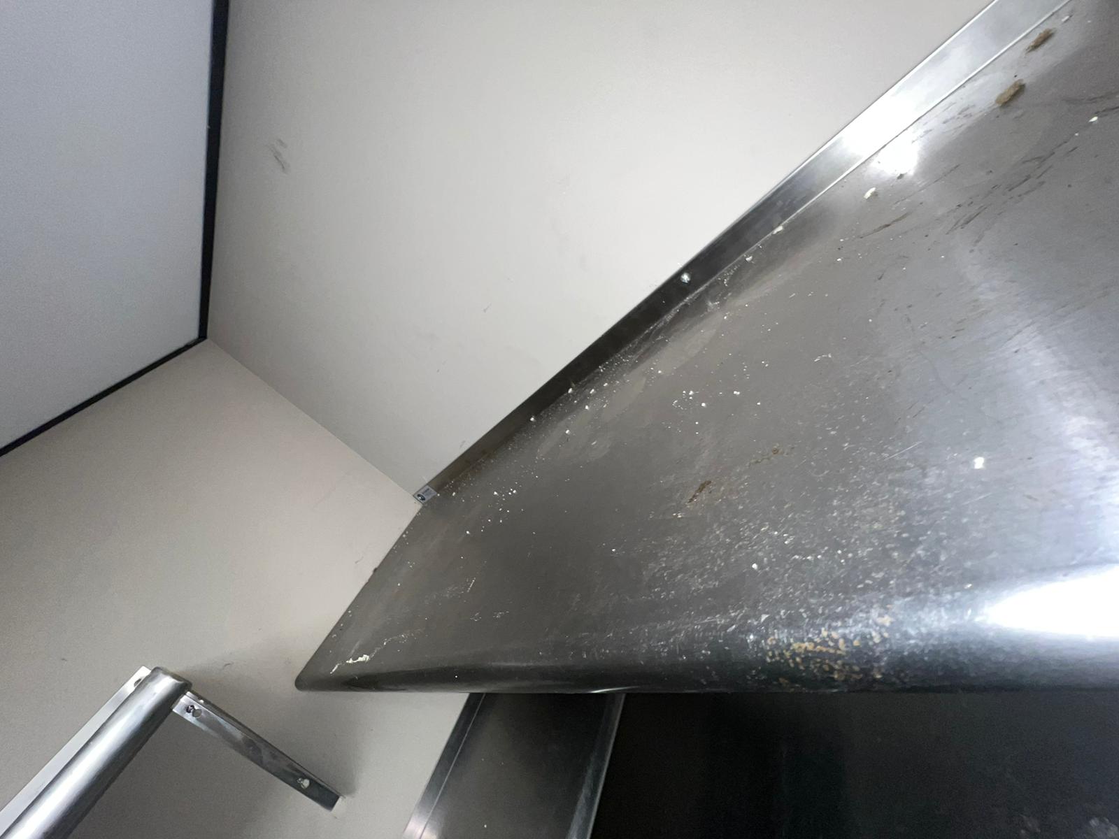 Stainless steel hood over a commercial kitchen cook line
