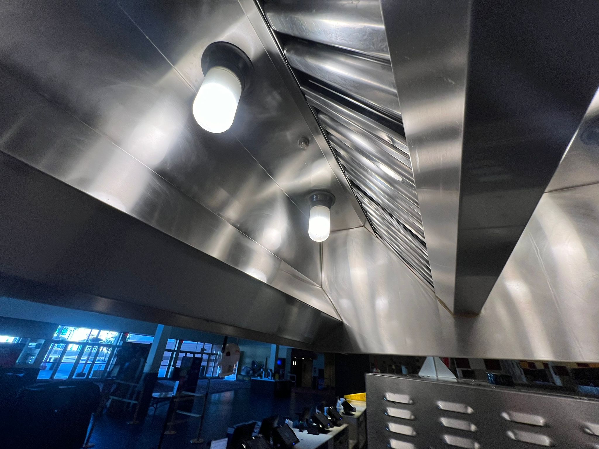 Stainless steel hood over a commercial kitchen cook line